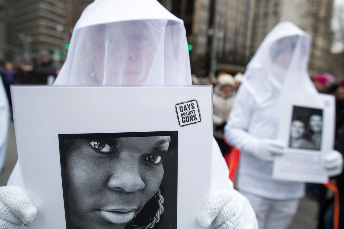 People participating in the NYC Women's March carry images of victims of gun violence (Mary Altaffer/AP/Shutterstock)